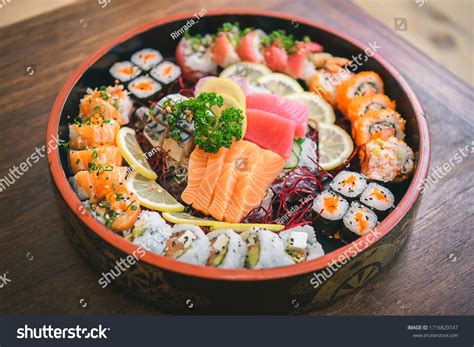 Thematic photo of sushi rolls and sashimi on a plate