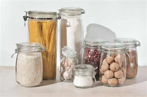 Frascos de vidrio usados para sostener servilletas y cubiertos en una mesa