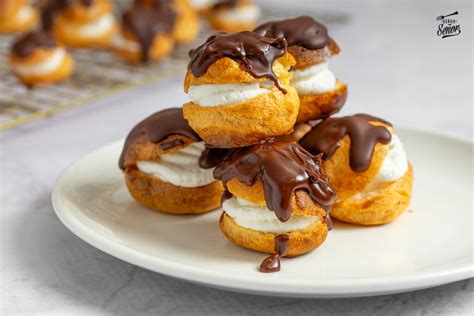 Profiteroles recién rellenos y decorados con chocolate