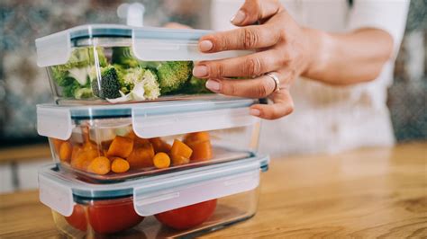 Persona organizando tápers con comida preparada