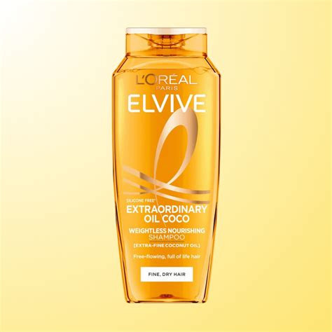 Botella del Champú Elvive Aceite Extraordinario con aceites florales esparcidos