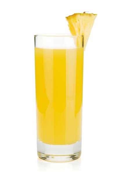 Foto de un vaso con jugo de piña, papaya y naranja decorado con una rodaja de fruta en un ambiente tropical