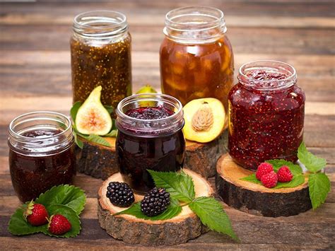 Thematic photo of a breakfast table with various jars of jam, jelly, and preserves