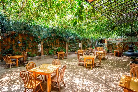 Paisaje natural con mesas al aire libre en un restaurante familiar.