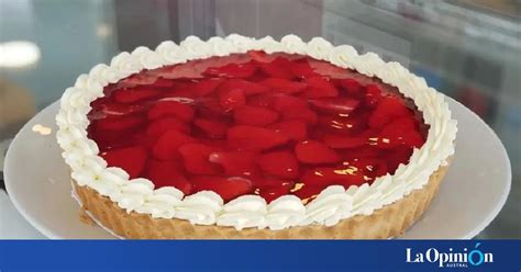 Tarta de frutillas con base crujiente y crema decorada con rodajas de fruta fresca