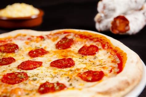 Comparativa visual de diferentes tipos de masas de pizza: fina y crujiente vs. esponjosa