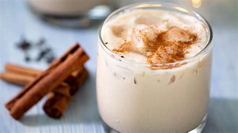 Infografía con los ingredientes clave del Cola de Mono: leche, aguardiente, café, especias (canela, clavo, anís) y cacao.