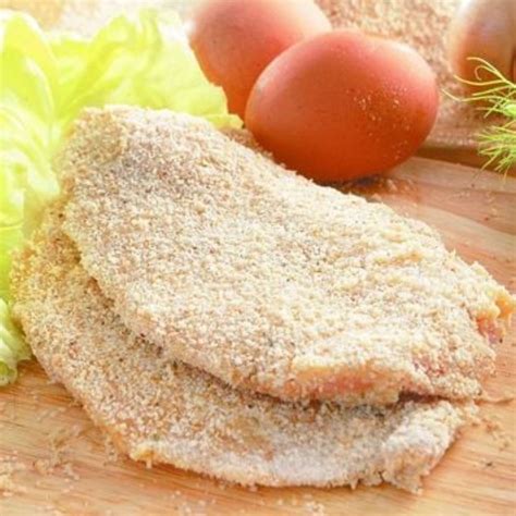 Foto de primer plano de milanesas de pollo con rebozador casero y hierbas