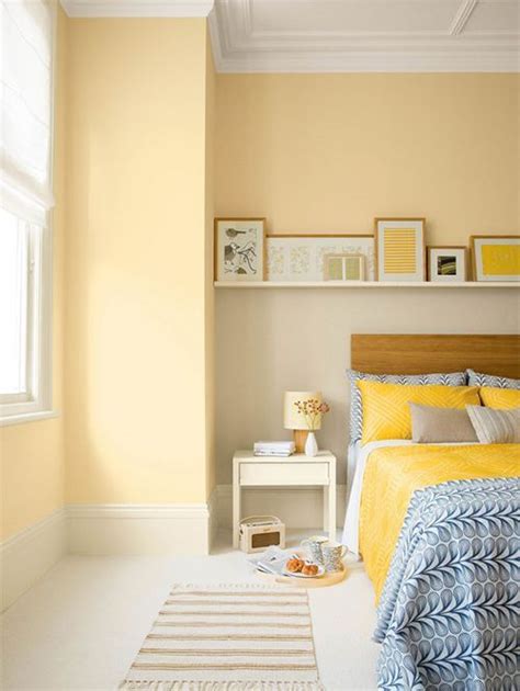Ejemplo de una habitación infantil combinando amarillo pastel y azul claro en muebles y textiles.