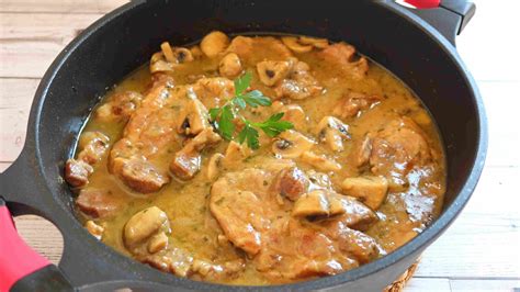 Sartén con filetes de cerdo dorándose y agregando la cerveza para la salsa.