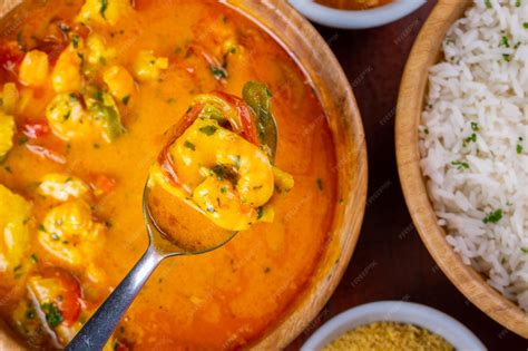 Plato de moqueca de salmón y camarones, vista superior, guarnición de arroz y cilantro