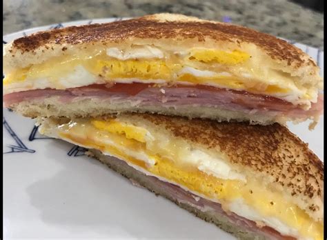 Sándwich con huevo cocido envolviendo el pan en una sartén