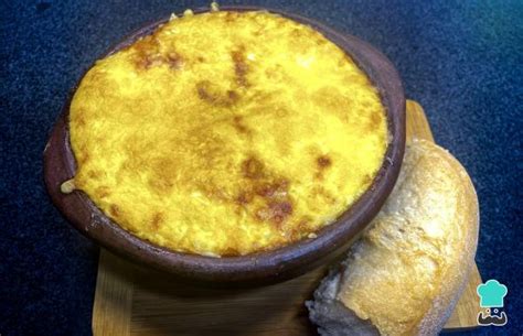 Fotografía gastronómica de un chupe de guatitas servido en una tradicional fuente de greda humeante.