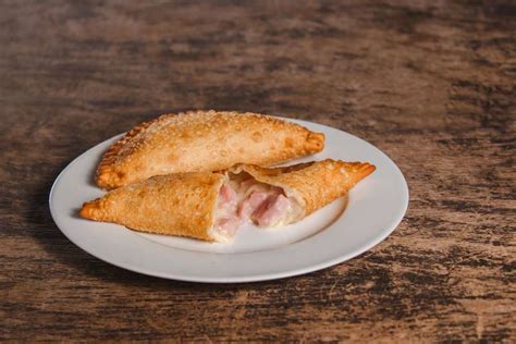 Plato de empanadas de cóctel de jamón, queso crema y perejil