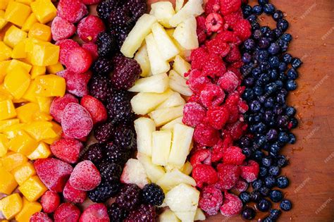 Ilustración de frutas congeladas variadas (fresas, arándanos, mango) en un bol