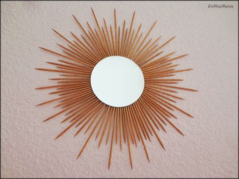 Foto de un espejo decorado con palitos de brocheta en forma de sol