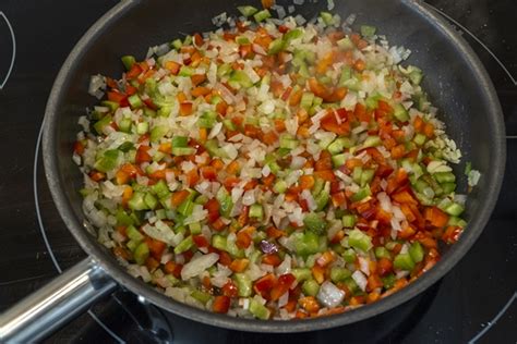 Esquema de preparación paso a paso: dorado de carne, sofrito con verduras y cocción de fideos.