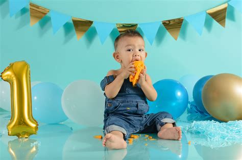 Bebé feliz celebrando su primer cumpleaños con un smash cake sin azúcar