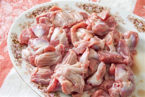 fotografía de mollejas de pollo crudas siendo limpiadas