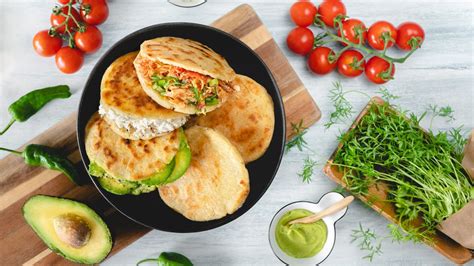 Infografía con la historia y origen de las arepas, destacando su conexión con el maíz y las culturas indígenas.