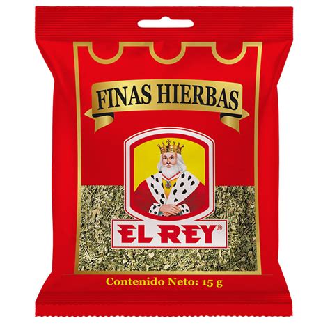 Fotografía gastronómica de un frasco de Finas Hierbas El Rey junto a ingredientes frescos como albahaca, romero y tomillo sobre una superficie de madera.
