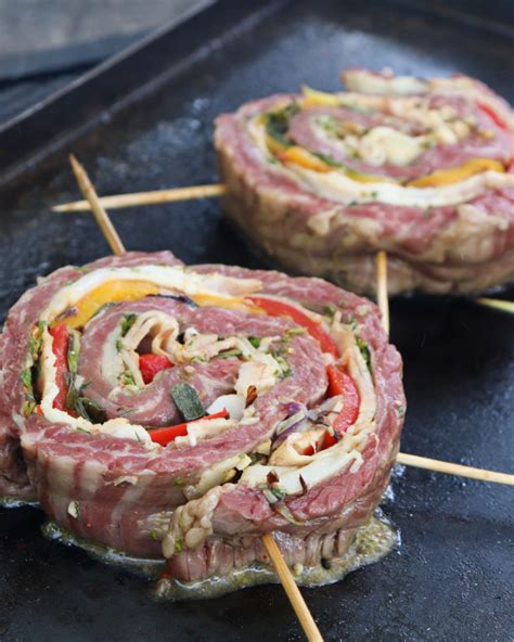Fotografía gastronómica de una entraña rellena lista para servir, mostrando su corte transversal con los vegetales y la panceta.